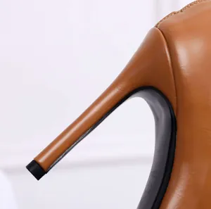 Detailed close-up showing the slim stiletto heel of a tan leather peep-toe dance boot