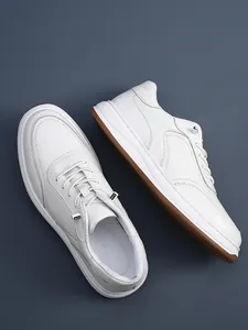 Detailed macro view of premium white cowhide leather sneakers with breathable texture