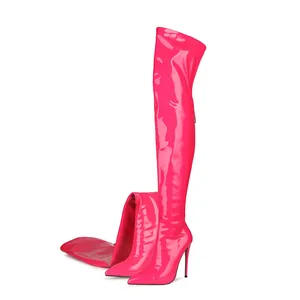 Detailed view of hot pink patent leather thigh-high boots with pointed toe and stiletto heel