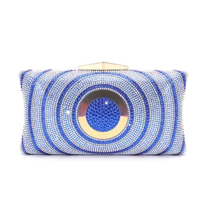 Elegant evening clutch bag decorated with blue and white rhinestones and gold circle