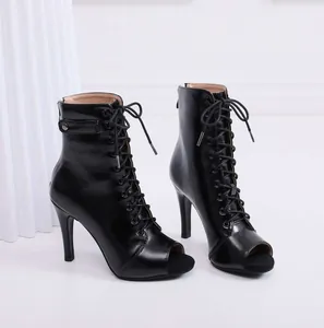 Close-up detail of black peep-toe stiletto lace-up boots for jazz dance and fashion