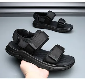 Macro detail view of men's black sporty beach sandals featuring adjustable velcro straps.