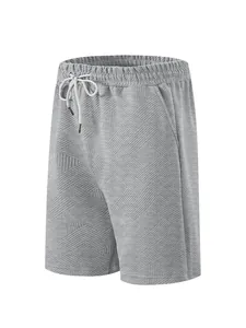 Detailed view of grey textured jacquard fabric on men's high street style shorts.