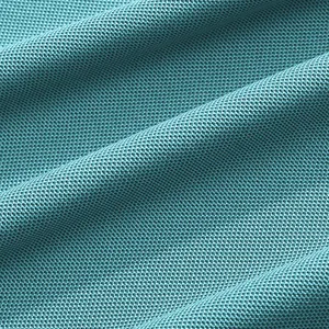 Macro view of teal piqué fabric showing breathable knit detail for premium polo shirt
