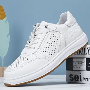 Detailed view of men's white perforated leather sneakers with no-tie elastic laces