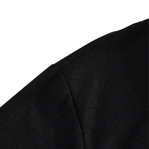 Close-up macro shot of the breathable black fabric texture on a men's golf polo shirt