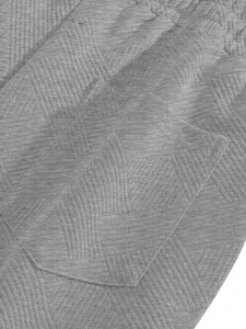 Detail shot of grey men's shorts showing heavy jacquard texture and pocket stitching