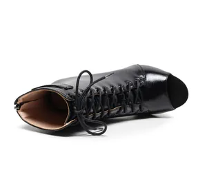 Detailed side view of black leather peep-toe lace-up dance boots with stiletto heels
