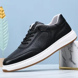 Close-up detail showing the perforated soft leather texture of these black men's casual sneakers.