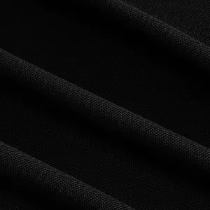 Macro view showing the breathable mesh texture of black quick-dry fabric on Polo shirt