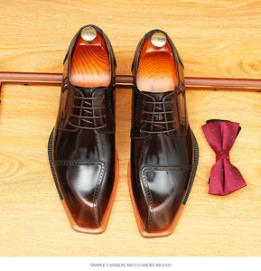 Elegant top-down view of glossy brown blade-toe derby shoes on a wood surface
