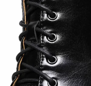 Macro close-up of black leather lace-up detail on stylish jazz dance high heel boots
