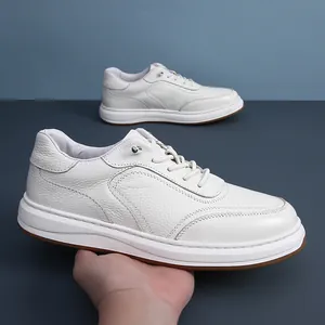 Close-up of soft cowhide leather texture and elastic laces on men's white sneakers