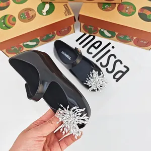 Vista detallada de los zapatos Melissa negros para niños con copo de nieve plateado