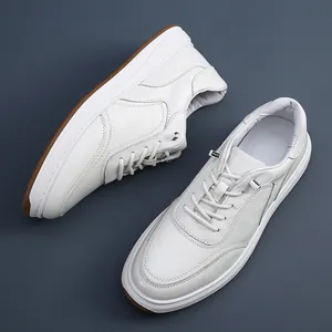 Top-down close-up detail of white men's leather sneakers with no-tie elastic laces