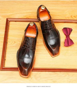 Detail of glossy blade-toe leather derby shoes with burnished finish on wooden tray