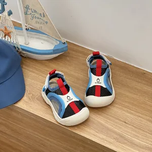 Dettaglio di sandali sportivi per bambini in rete traspirante con punta chiusa blu e rossa