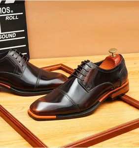 Detail shot of vintage burnished leather derby shoes with orange blade sole.