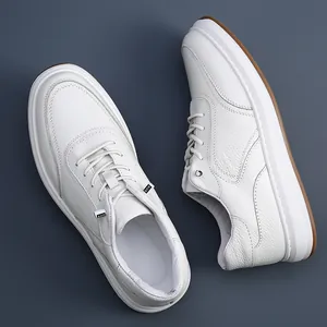 Top-down view of men's white perforated leather sneakers featuring elastic no-tie laces.
