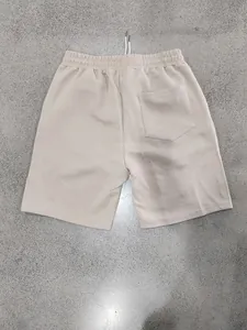 Back view detail of men's beige shorts featuring heavy jacquard geometric texture