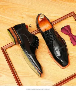 Detailed top view of shiny black patent leather Derby shoes with unique blade toe design.
