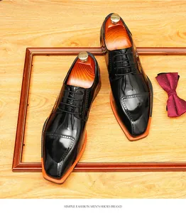 Top view of glossy black men's Derby shoes with unique orange square blade toe