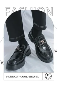 Close-up of men's chunky platform black leather shoes with crocodile texture and K buckle