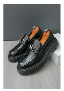 Detailed close-up of men's black crocodile embossed leather platform business loafers
