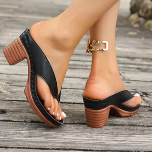 Elegant black thong sandals with chunky wooden-style heels for summer beach wear.