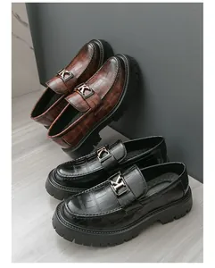 Detailed view of crocodile patterned platform leather loafers for men in black and brown