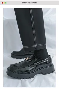 Detailed view of men's black crocodile pattern platform loafers with a stylish metal buckle