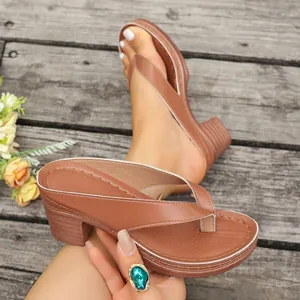 Close-up detail of brown high heel flip-flop sandals with platform sole and block heel