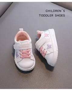 Detail of butterfly embroidery on white leather toddler walking shoes for girls