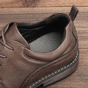 Close-up of brown leather men's dress shoe showing textured finish and stitching.