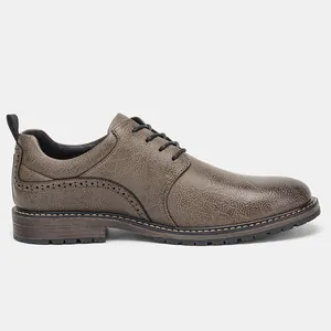 Detailed side view of men's brown textured leather oxford dress shoes with brogue details