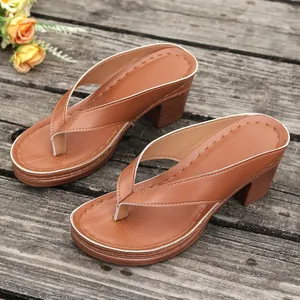 Stylish brown block heel platform thong sandals with detailed stitching on wooden planks