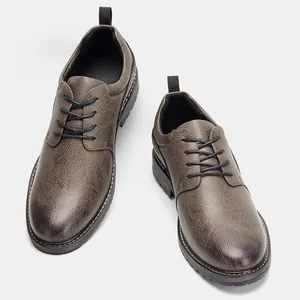 Top-down view of men's casual brown textured leather dress shoes with round black laces
