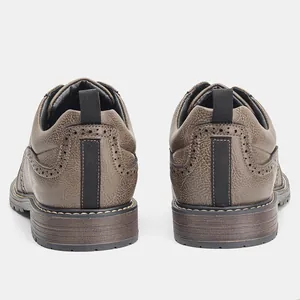 Detail view of men's brown leather brogue shoes focusing on the heel and sole structure