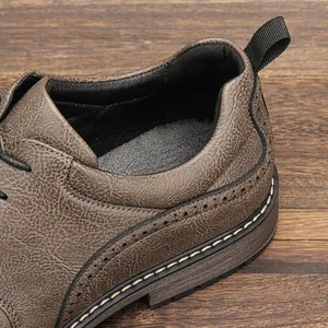 Detailed view of brown textured leather men shoe showing fine stitching and heel tab.