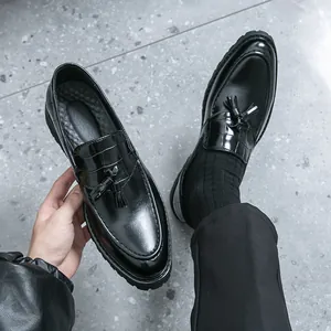 Classic black men's British style tassel loafers with elegant crocodile texture detailing