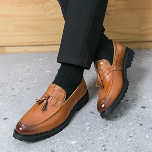 Men's British style tan leather loafers with decorative tassels and crocodile texture