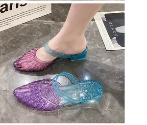 Close-up of purple gradient glitter jelly sandals with woven pattern and low heel