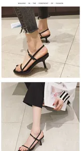 Detail view of stylish black stiletto sandals with thin ankle straps and open toe design