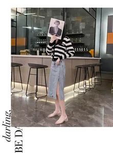 Stylish clear jelly wedge sandals worn by a model in a modern indoor bar setting