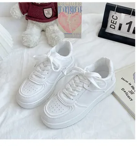 Top-down view of stylish white platform sneakers on a soft, cozy lifestyle background