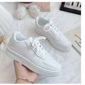 Close-up of white casual sneakers for women showing the side profile and platform sole
