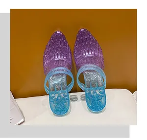 Detailed view of glitter gradient purple to blue jelly clogs with flower pattern