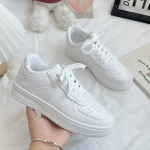 Minimalist white leather platform sneakers for women in a bright lifestyle setting