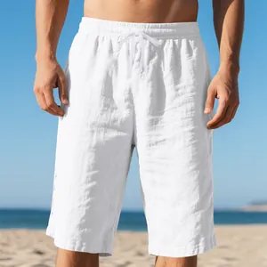 Close-up of white breathable linen shorts with drawstring waist on beach