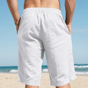 Back view detail of white breathable linen beach shorts with an elastic waist design.